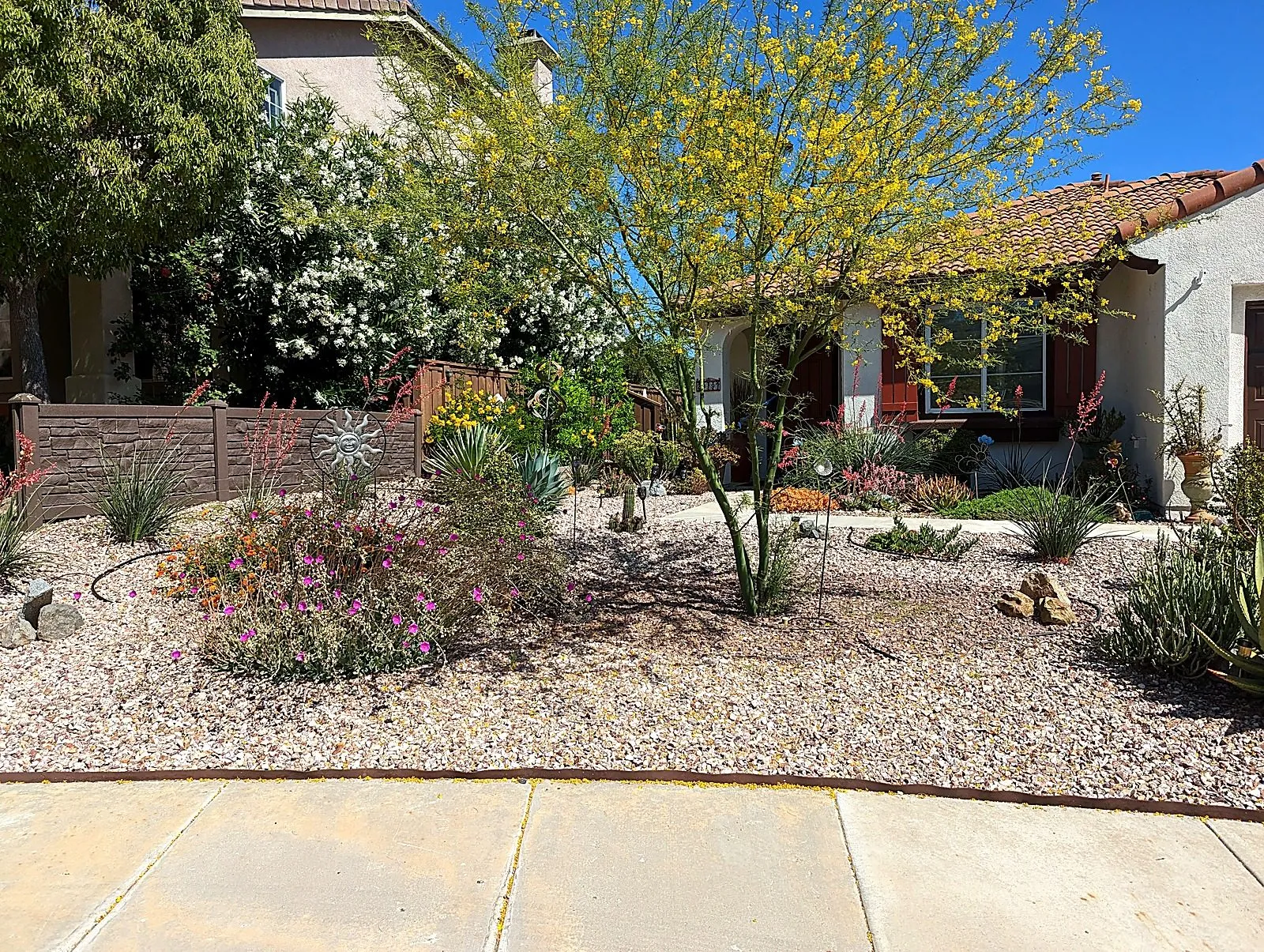 Front garden bed finished with decorative gravel, fresh mulch and drought-tolerant shrubs